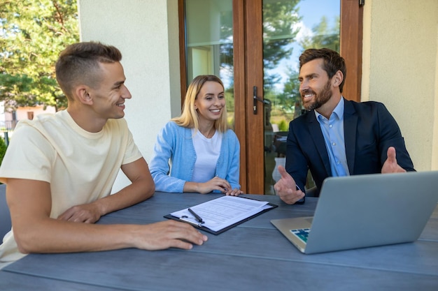 real estate agent discussing deal details with clients 259150 86027